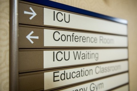 A hallway sign with room names and arrows at Shepherd Center for rehabilitation